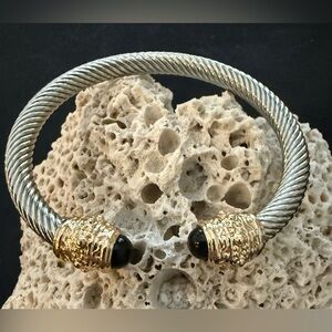 Truly stunning designer style bangle. Stainless/gold tones/black stones.